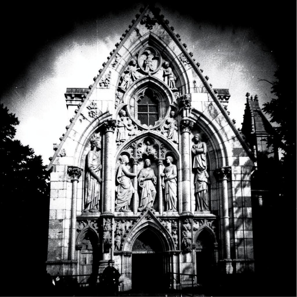 Duotone photograph in deep brown and cream tones of an ornate Masonic archway with symbolic detailing, evoking heritage and solemnity.